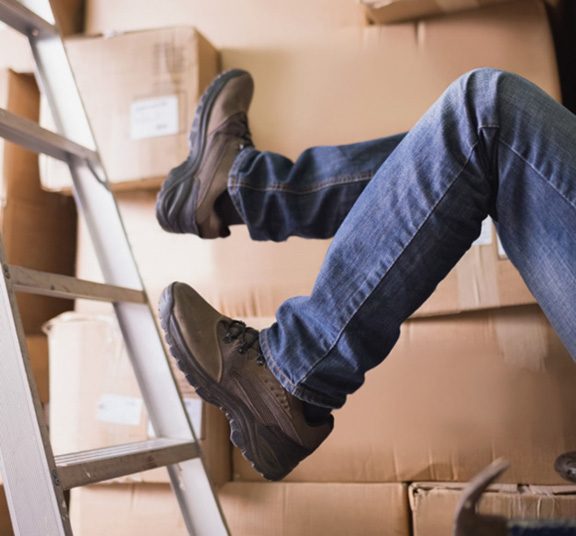A-warehouse-worker-falls-in-the-middle-of-disorganized-boxes-1